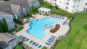 an aerial view of a large swimming pool in front of an apartment building at Latitudes Apartments, Indiana, 46237